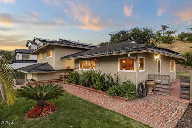 a front view of a house with a garden