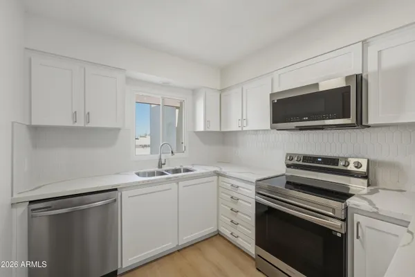 a kitchen with a sink stove and microwave