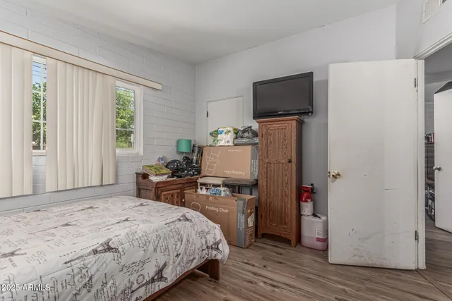 a bedroom with a bed and a couch