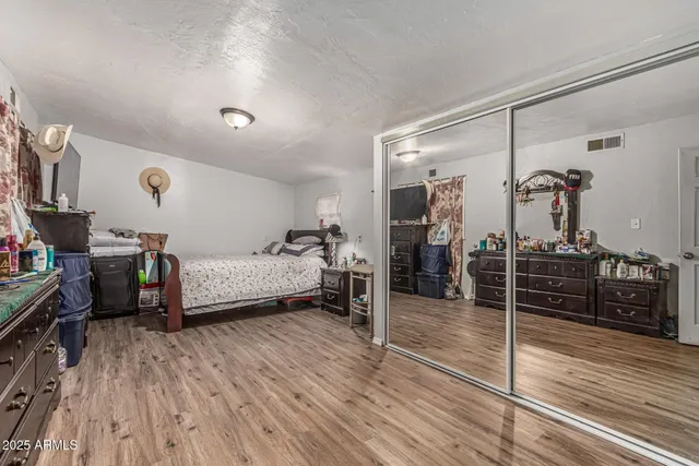 a room with wooden floors and wooden cabinets