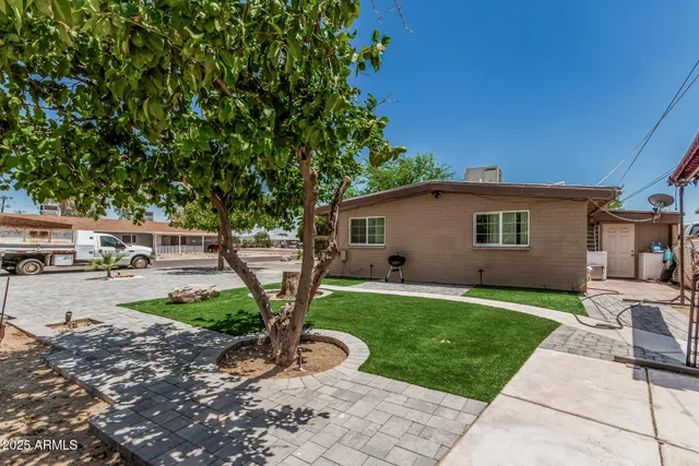 a backyard of a house with yard and outdoor seating
