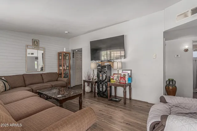 a view of a livingroom with furniture and a flat screen tv