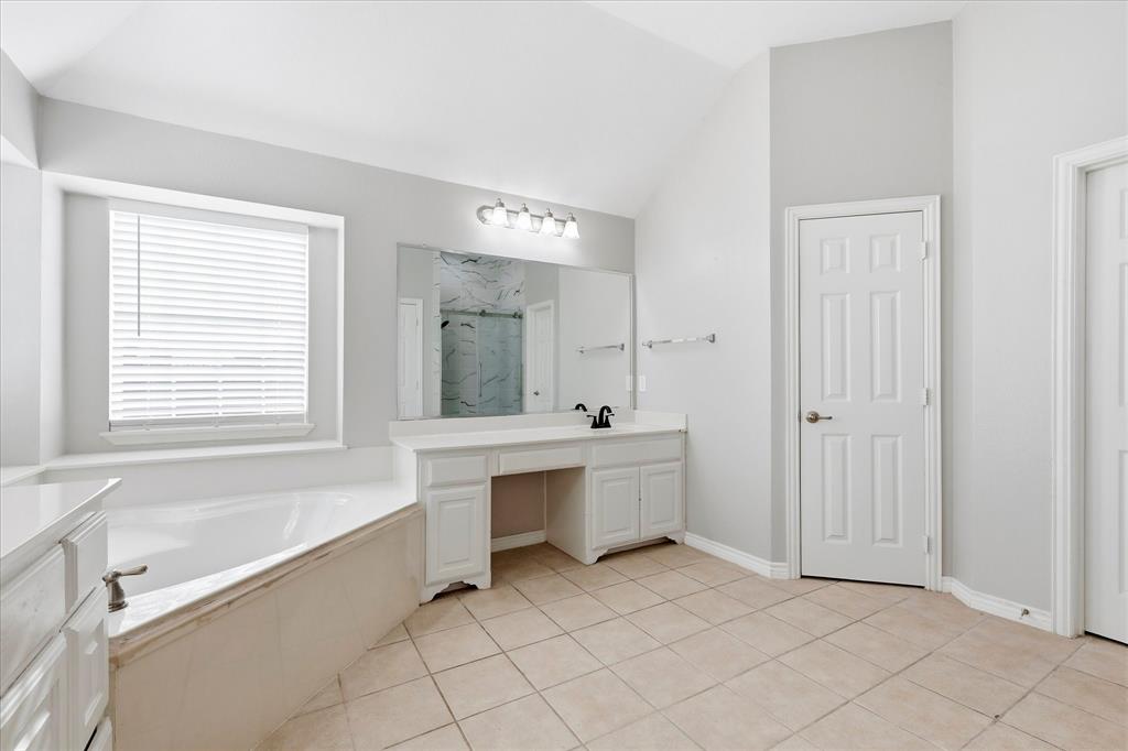 2147 Hunt Club Trail Frisco, TX 75033 - Photo 16 of 27 a bathroom with a bathtub and a sink