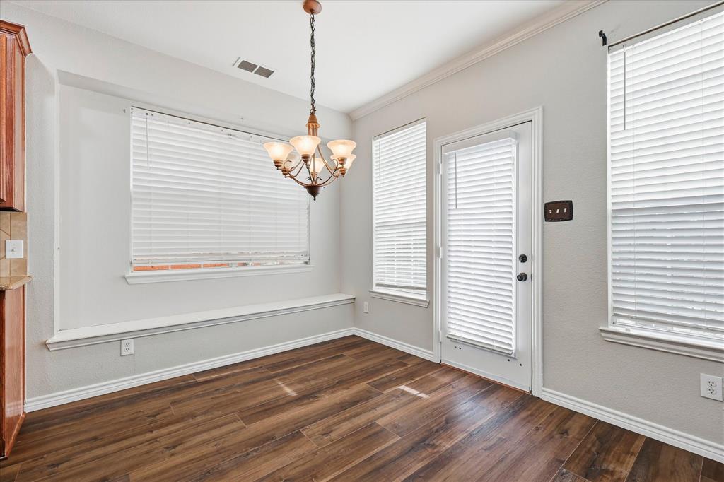 2147 Hunt Club Trail Frisco, TX 75033 - Photo 10 of 27 a view of an empty room with wooden floor and a window