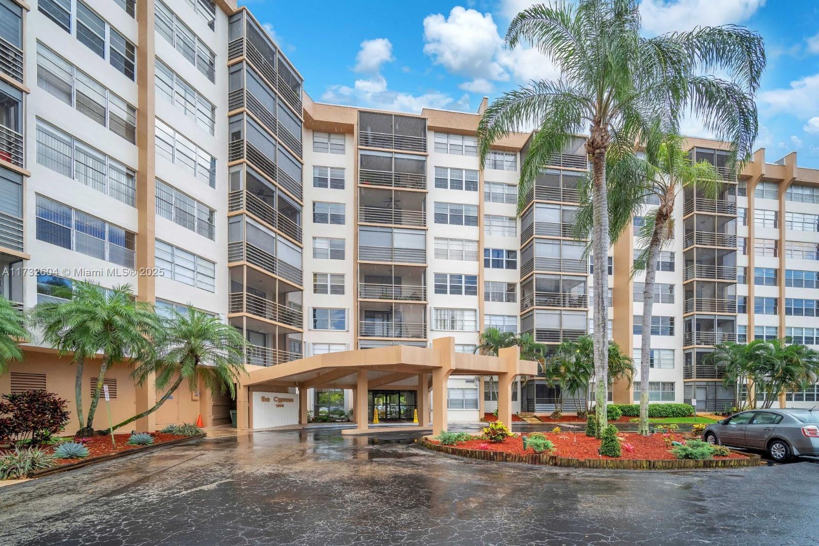 1200 St Charles Place, Unit 419 Pembroke Pines, FL 33026 - Photo 1 of 16 a front view of a building with street view
