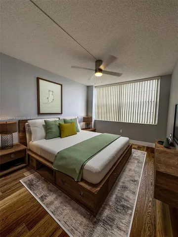 a bedroom with a bed and a night stand