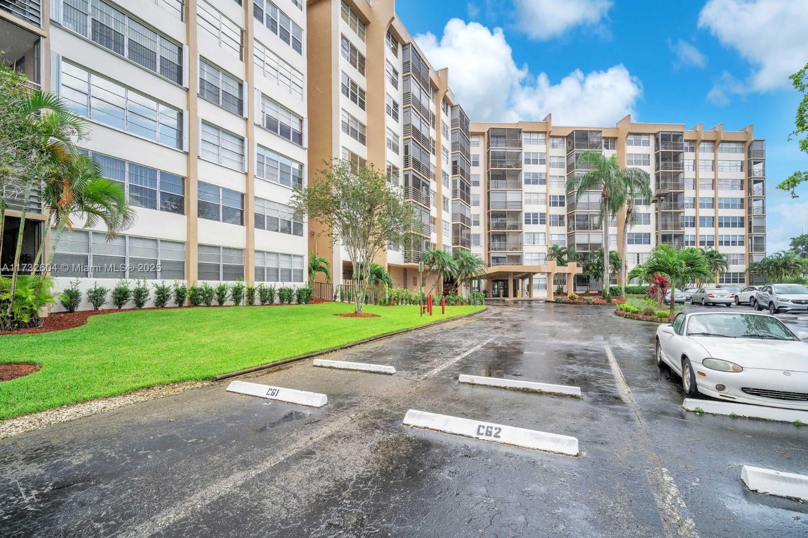 1200 St Charles Place, Unit 419 Pembroke Pines, FL 33026 - Photo 13 of 16 a city street lined with tall buildings