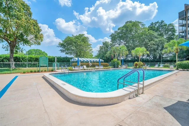 a view of a swimming pool with a yard