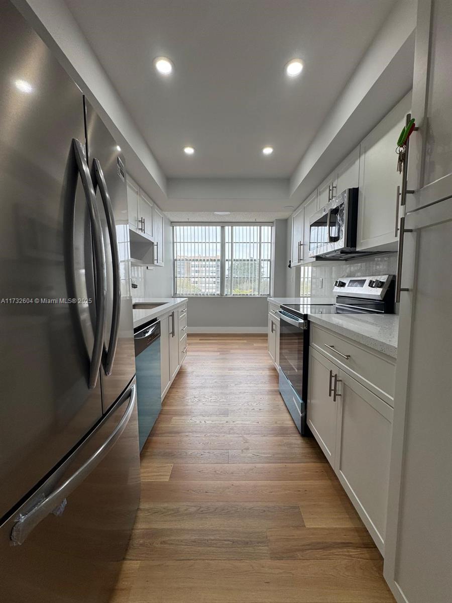 1200 St Charles Place, Unit 419 Pembroke Pines, FL 33026 - Photo 2 of 16 a large kitchen with stainless steel appliances lots of counter top space