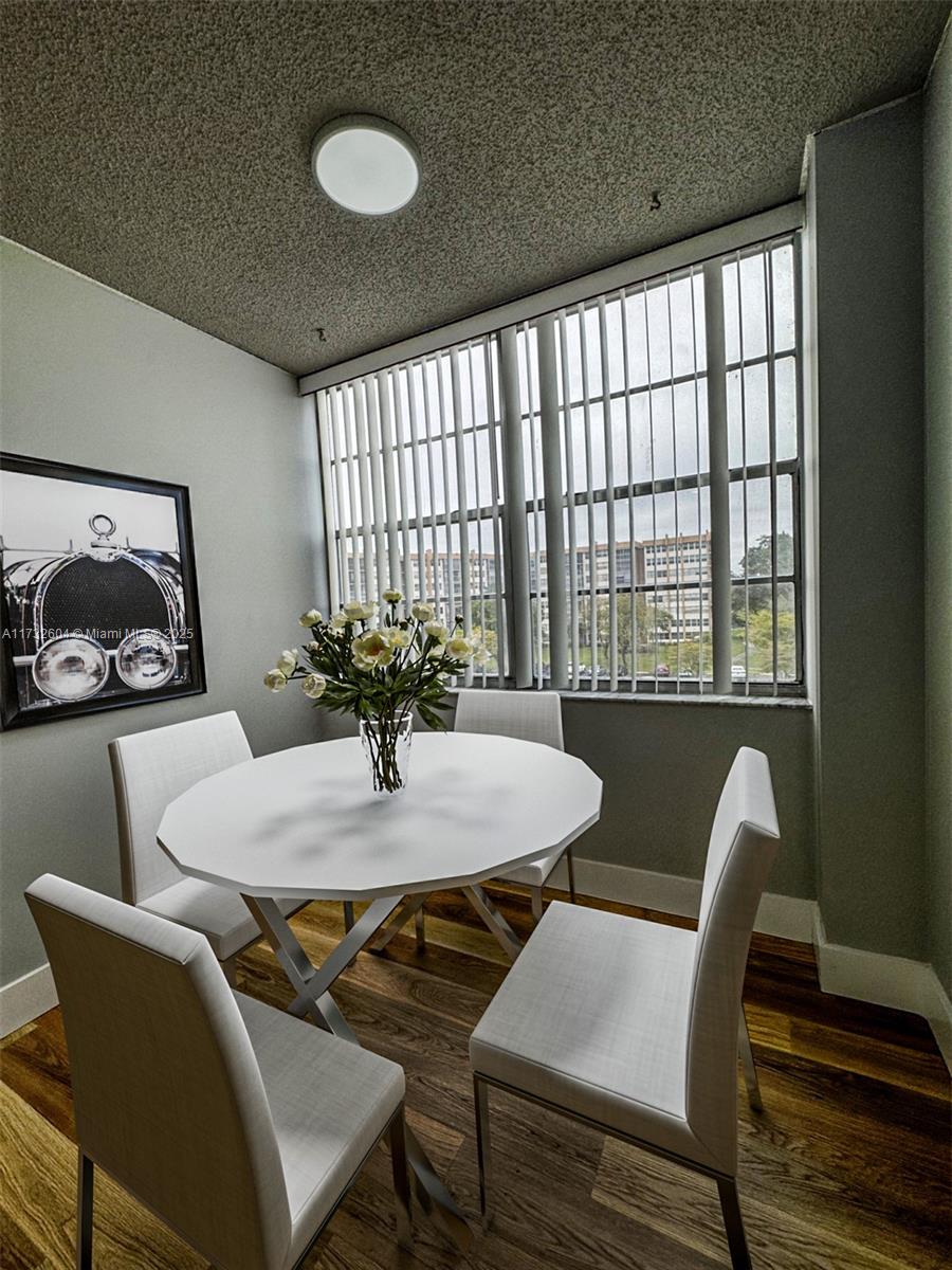 1200 St Charles Place, Unit 419 Pembroke Pines, FL 33026 - Photo 7 of 16 a view of a dining room with furniture window and wooden floor