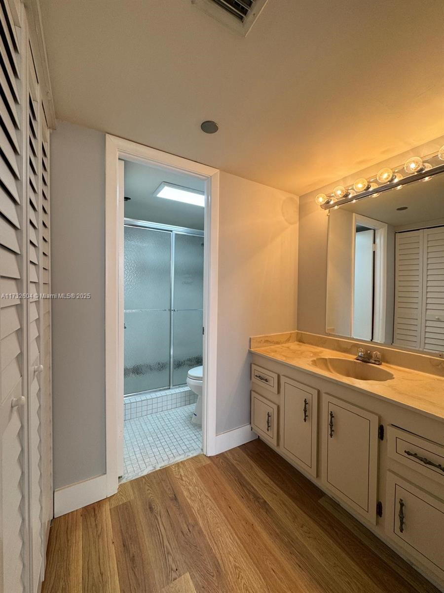 1200 St Charles Place, Unit 419 Pembroke Pines, FL 33026 - Photo 9 of 16 a bathroom with a granite countertop sink and a mirror