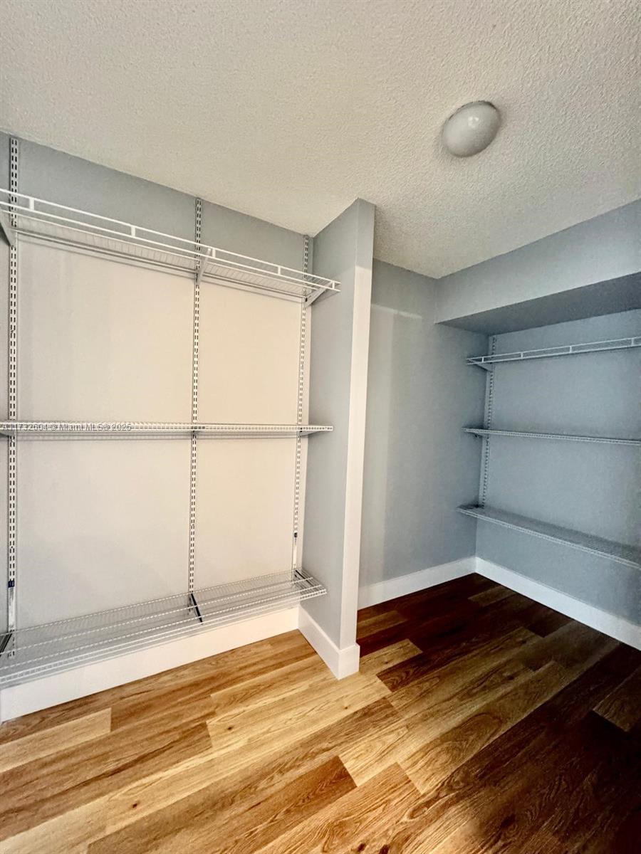 1200 St Charles Place, Unit 419 Pembroke Pines, FL 33026 - Photo 10 of 16 a view of a room with wooden floor and a window