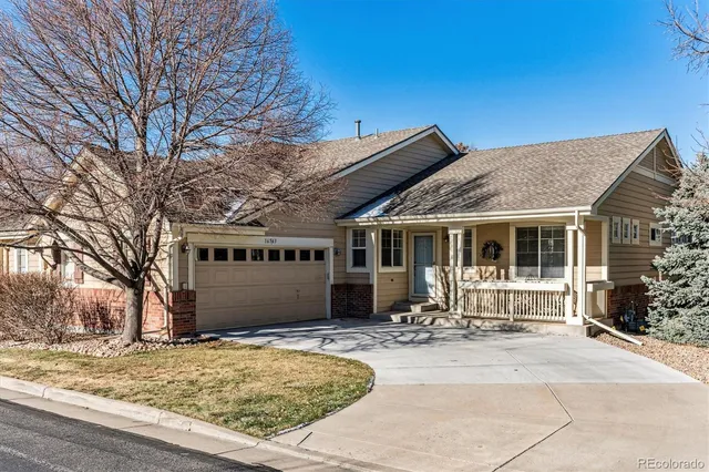 a front view of a house with a yard in front of it