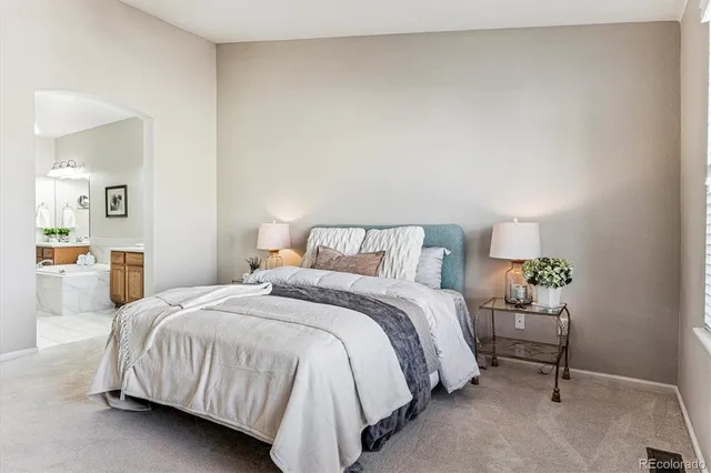 a bedroom with a bed and table