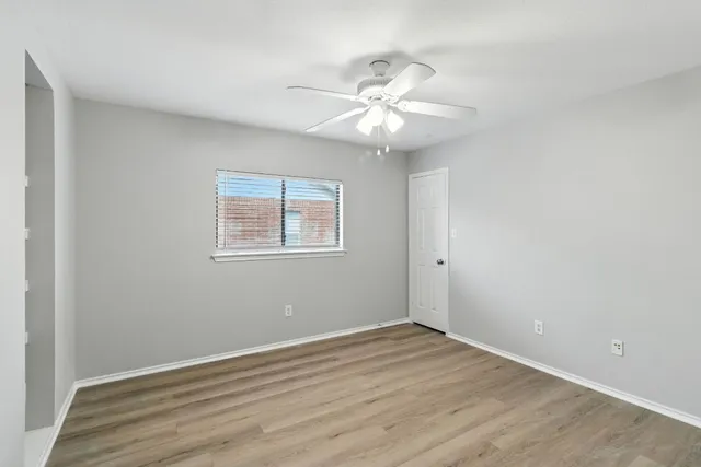 wooden floor in an empty room with a window