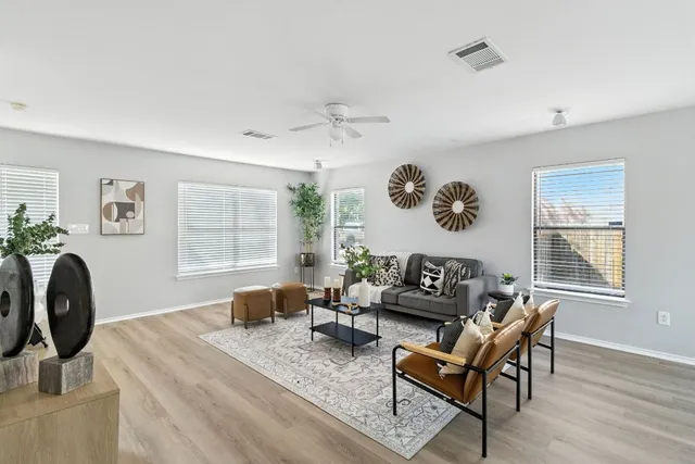 a living room with furniture and wooden floor