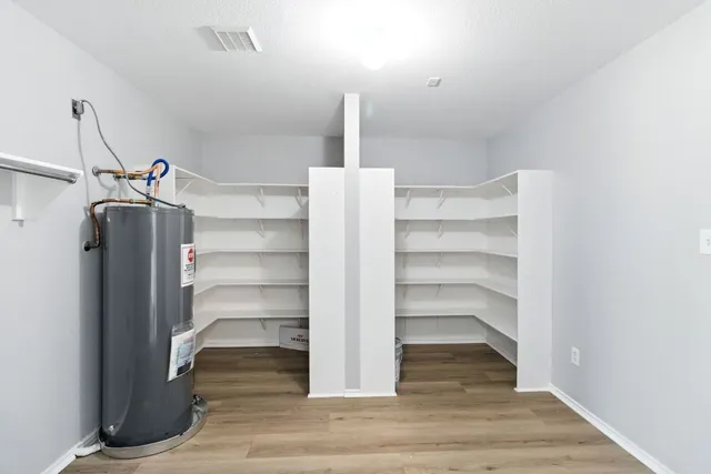 a kitchen with stainless steel appliances a stove a refrigerator and cabinets