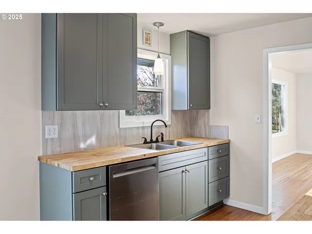 a kitchen with a sink cabinets and window
