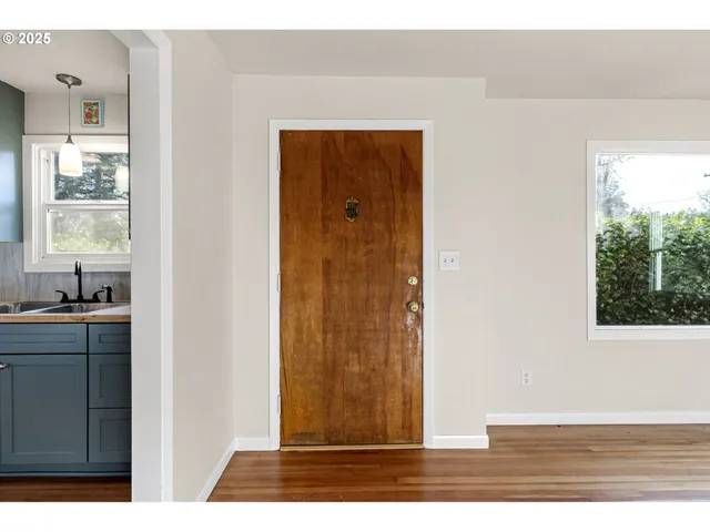 a view of a house with backyard and wooden fence