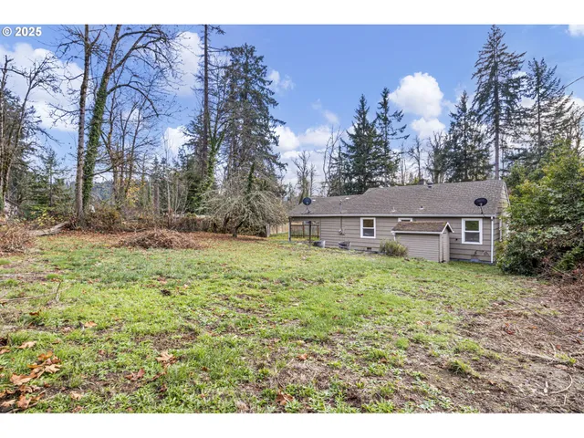 a aerial view of a house next to a yard