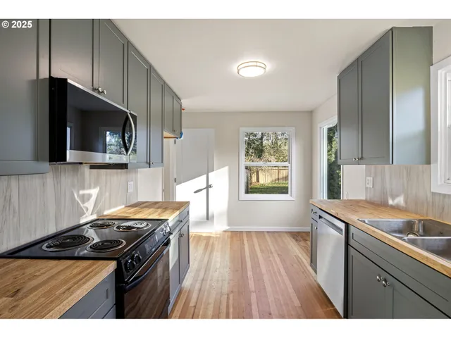 a kitchen with a stove a sink and a microwave