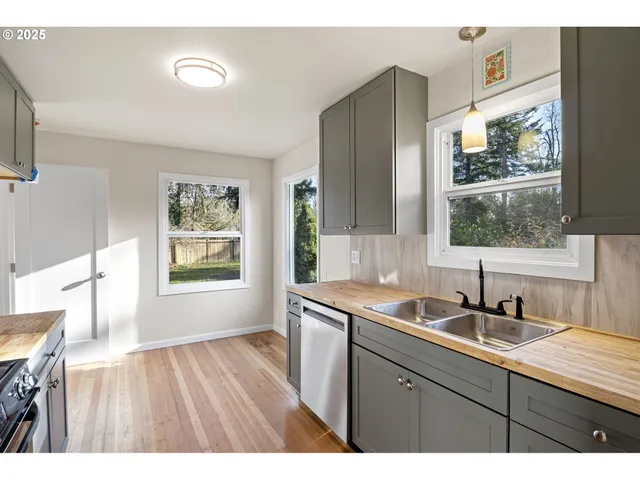 a kitchen with a sink cabinets and window