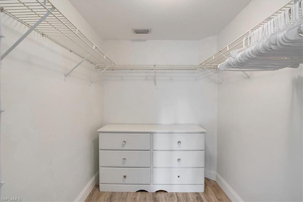1965 Courtyard Way, Unit E106 Naples, FL 34112 - Photo 15 of 25 Spacious closet featuring light wood-style floors