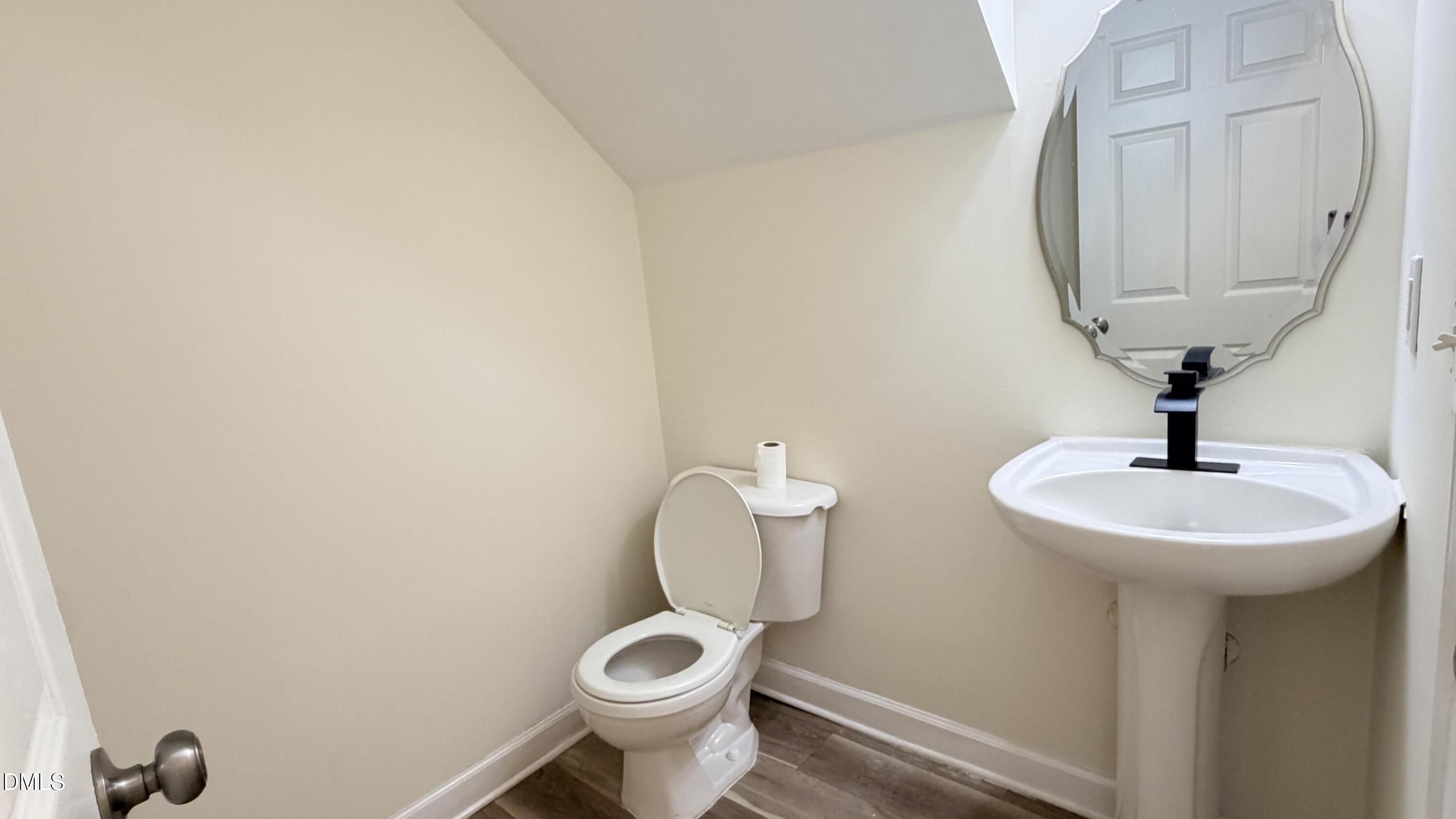 4123 Standing Rock Way Raleigh, NC 27604 - Photo 11 of 29 a bathroom with a toilet sink and mirror