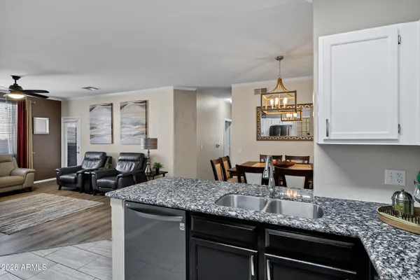 a kitchen with stainless steel appliances granite countertop a stove microwave and sink