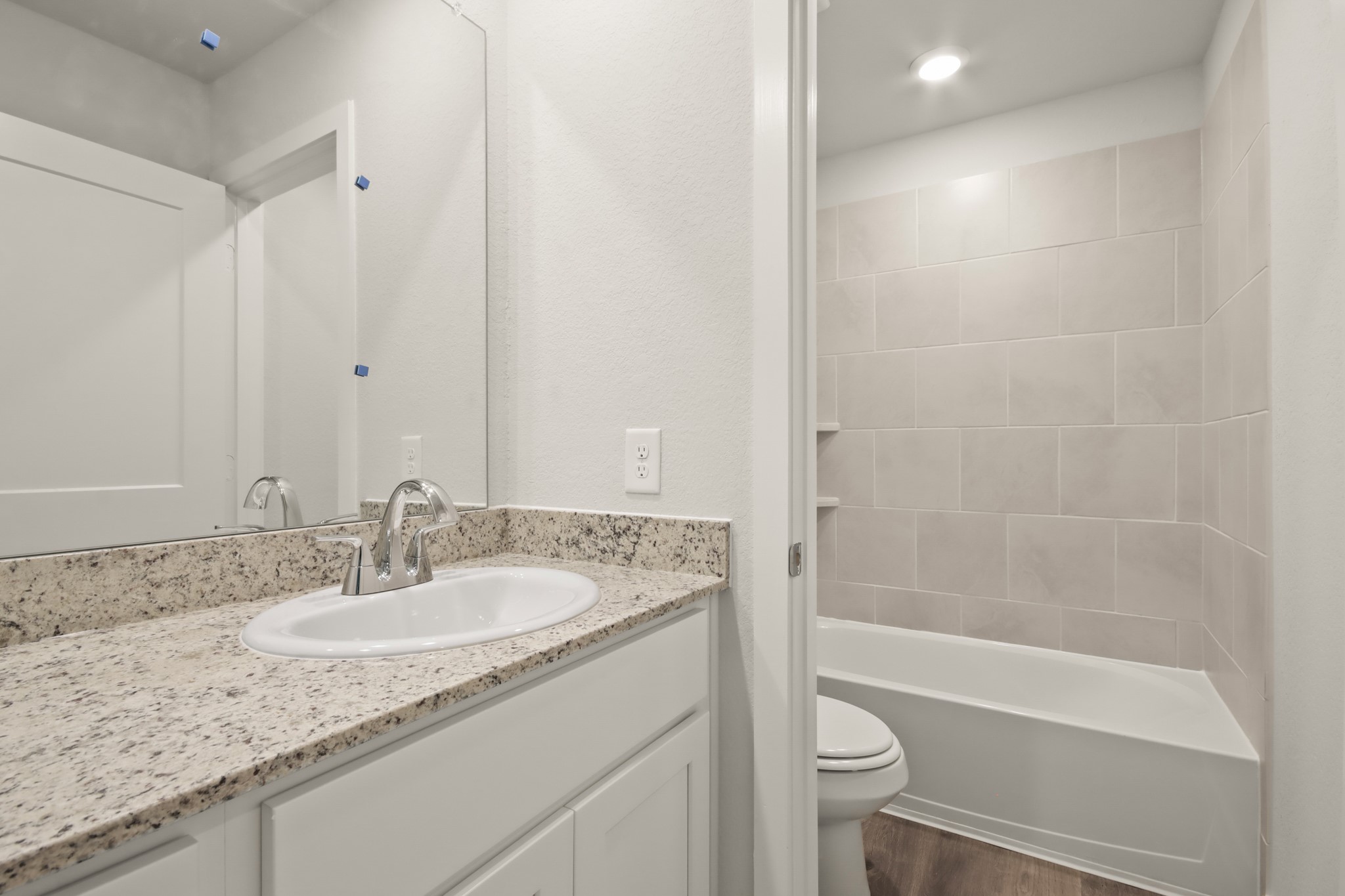 16922 Needlepoint Drive Conroe, TX 77302 - Photo 18 of 31 a bathroom with a granite countertop sink a toilet and shower