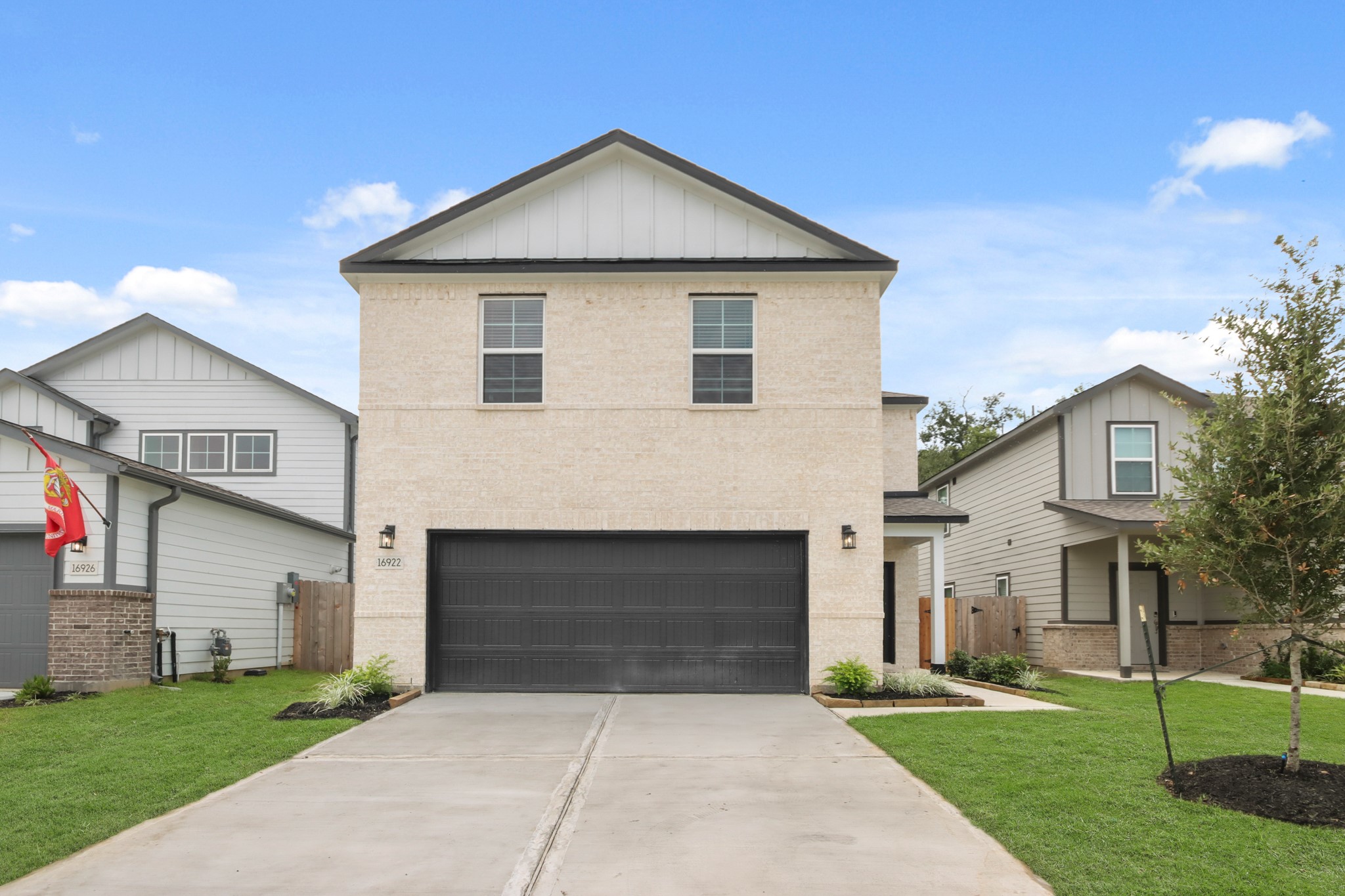 16922 Needlepoint Drive Conroe, TX 77302 - Photo 2 of 31 a front view of a house with a yard and garage
