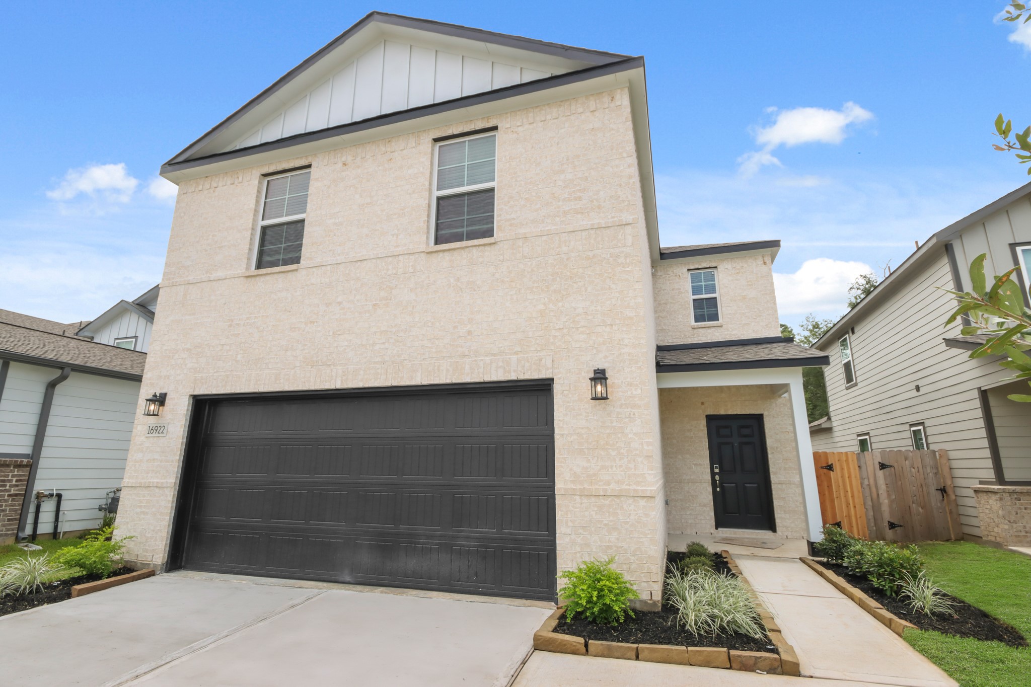 16922 Needlepoint Drive Conroe, TX 77302 - Photo 3 of 31 a front view of a house with a yard