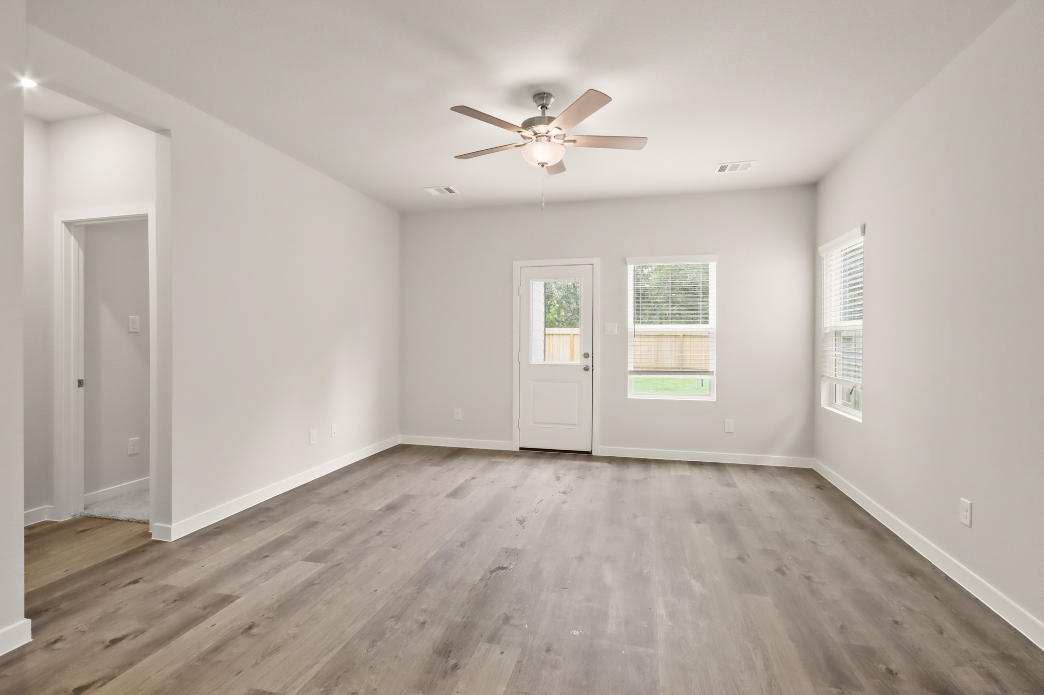 16922 Needlepoint Drive Conroe, TX 77302 - Photo 7 of 31 a view of an empty room with wooden floor and a window