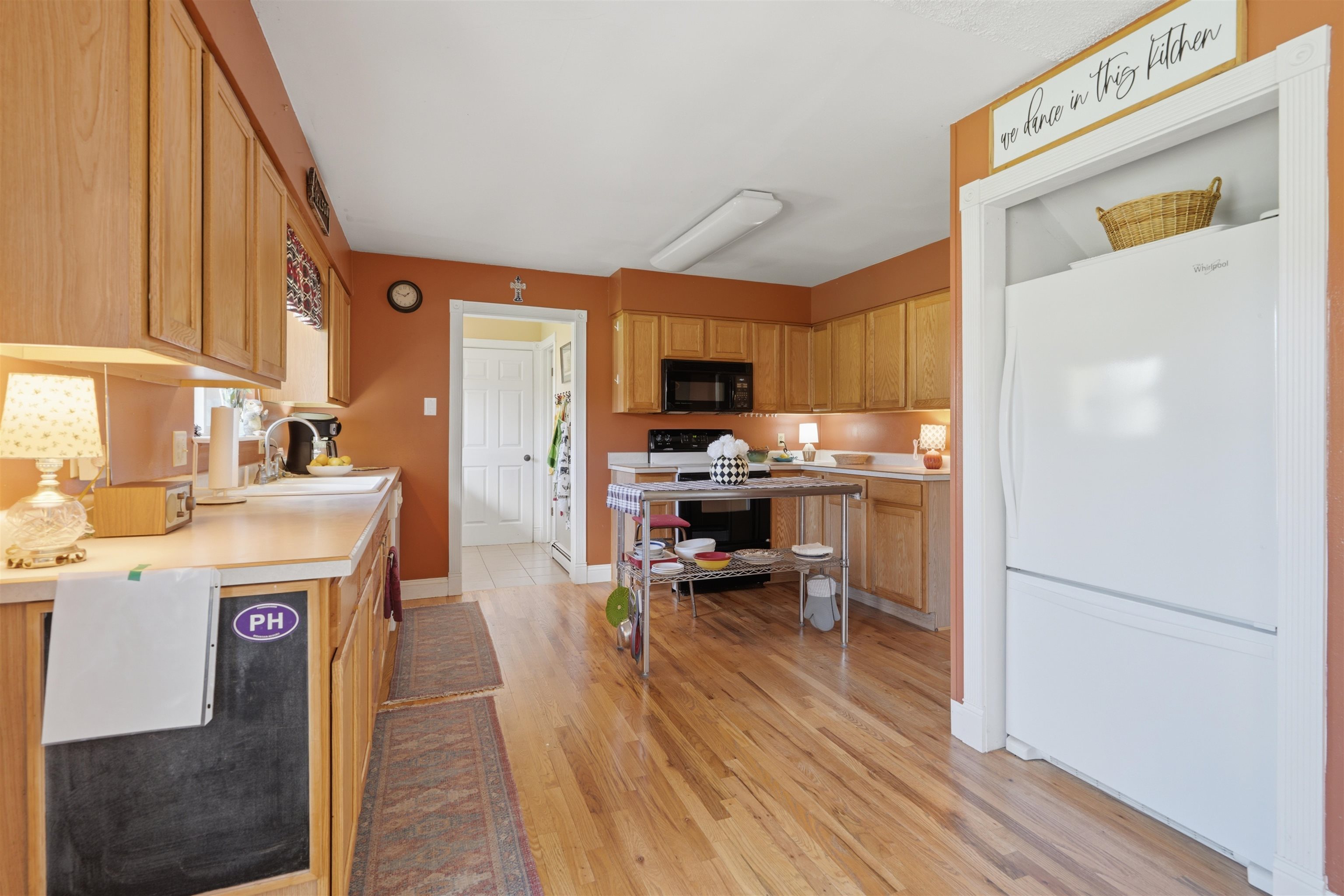 2350 E Road Grand Junction, CO 81507 - Photo 12 of 41 a kitchen with stainless steel appliances granite countertop a refrigerator a stove top oven a sink dishwasher and dining table with wooden floor