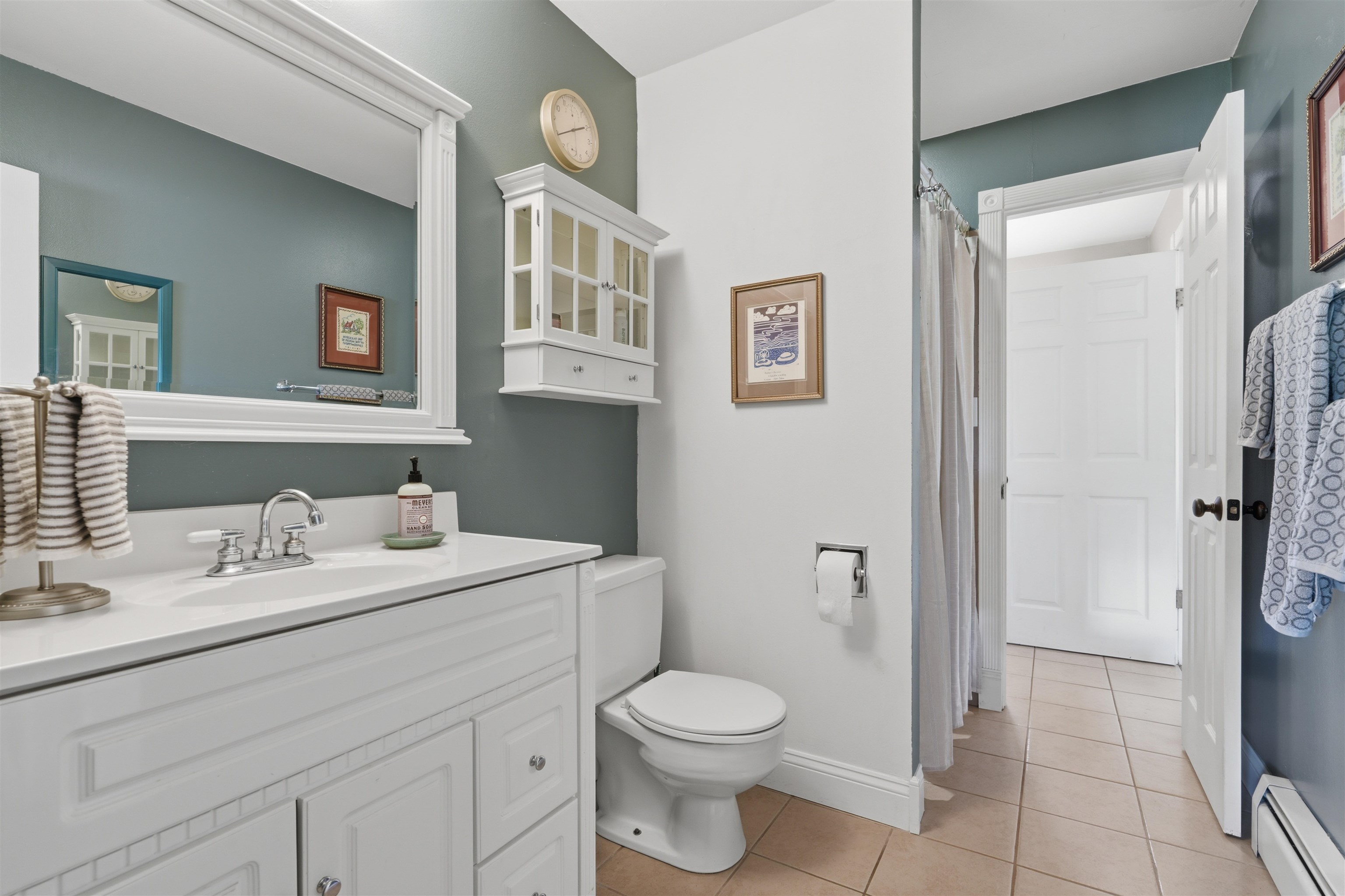 2350 E Road Grand Junction, CO 81507 - Photo 17 of 41 a bathroom with a toilet sink vanity and mirror