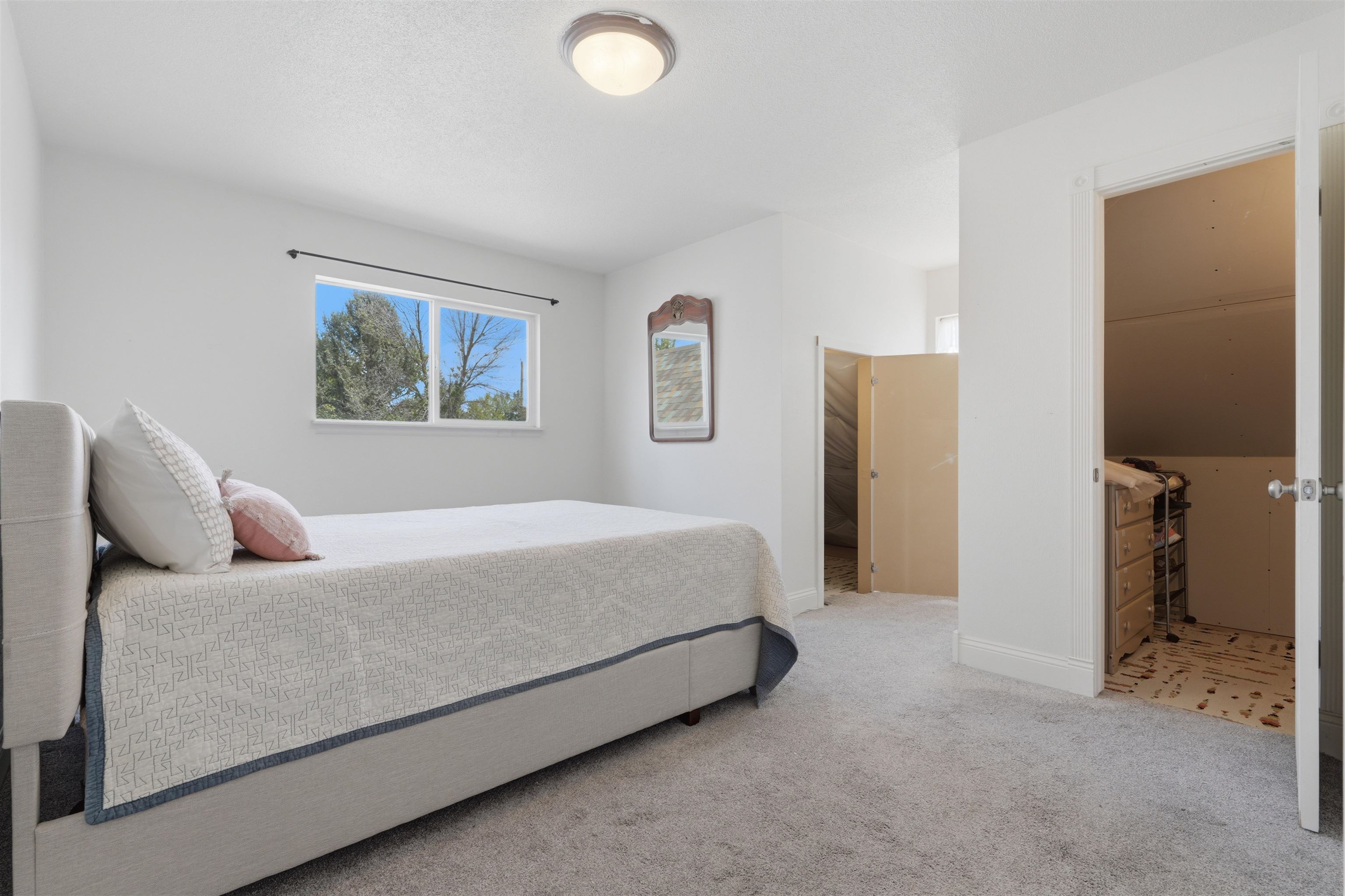 2350 E Road Grand Junction, CO 81507 - Photo 25 of 41 a bedroom with a bed and a painting on the wall