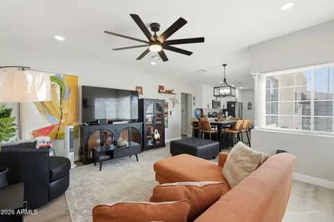 a living room with furniture ceiling fan and a window