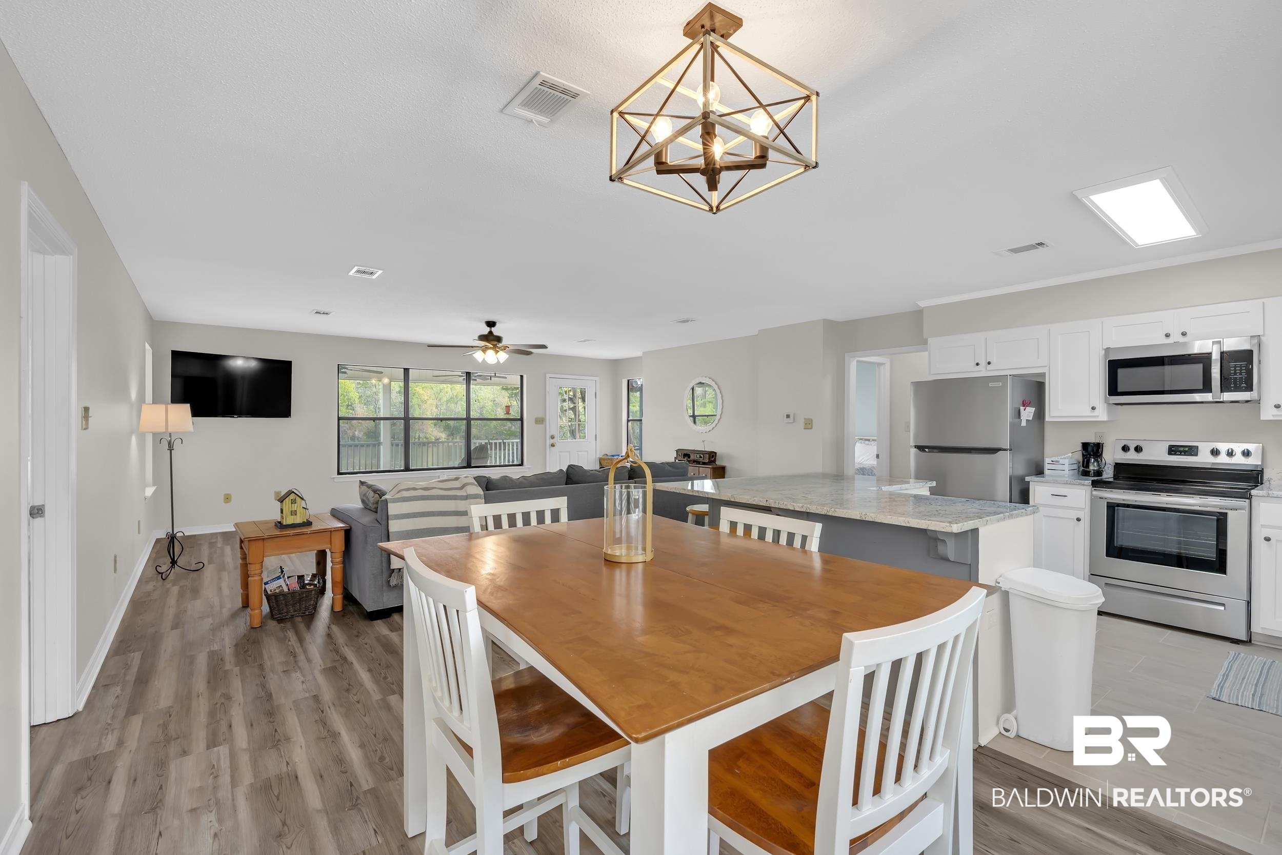8081 Bryant's Lndg Road Stockton, AL 36579 - Photo 25 of 48 Dining space featuring light wood finished floors, ceiling fan, and a chandelier