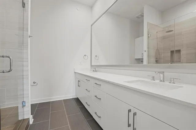 a bathroom with a granite countertop sink a toilet and a bathtub