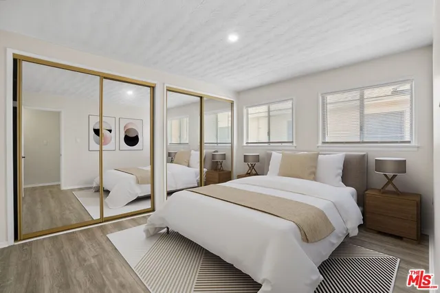 a bedroom with a bed and a mirror