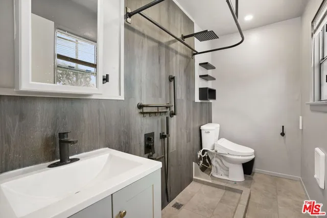 a bathroom with a sink toilet and shower