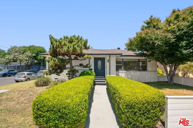 a view of a house with swimming pool and sitting area