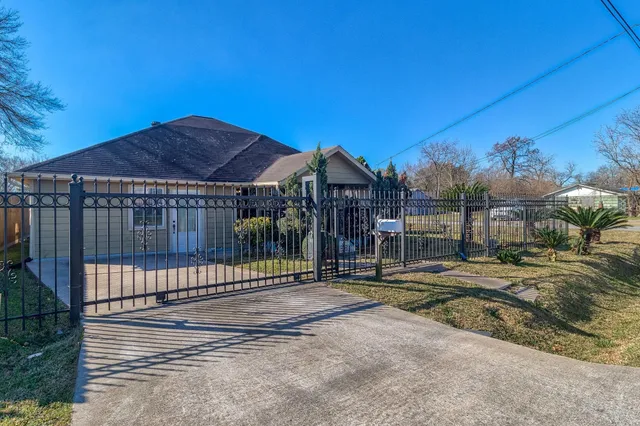 a view of a house with a backyard and a fire pit