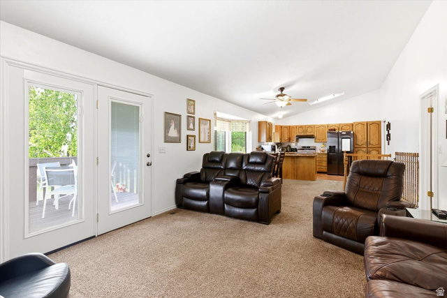 5321 South 3100th Street West Roy, UT 84067 - Photo 31 of 64 Open-concept living area featuring a vaulted ceiling and light brown carpeting