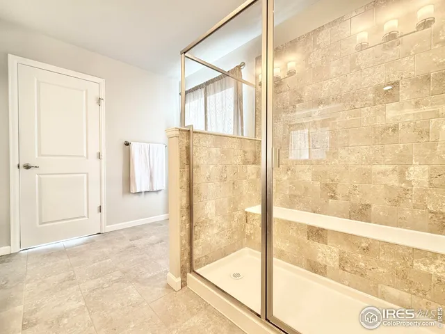 a bathroom with a glass shower door