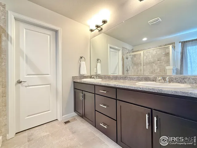 a bathroom with a granite countertop sink mirror and