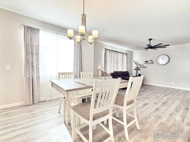 a view of a dining room with furniture and chandelier