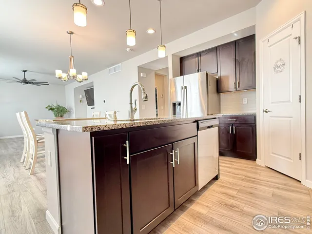 a kitchen with kitchen island cabinets and refrigerator