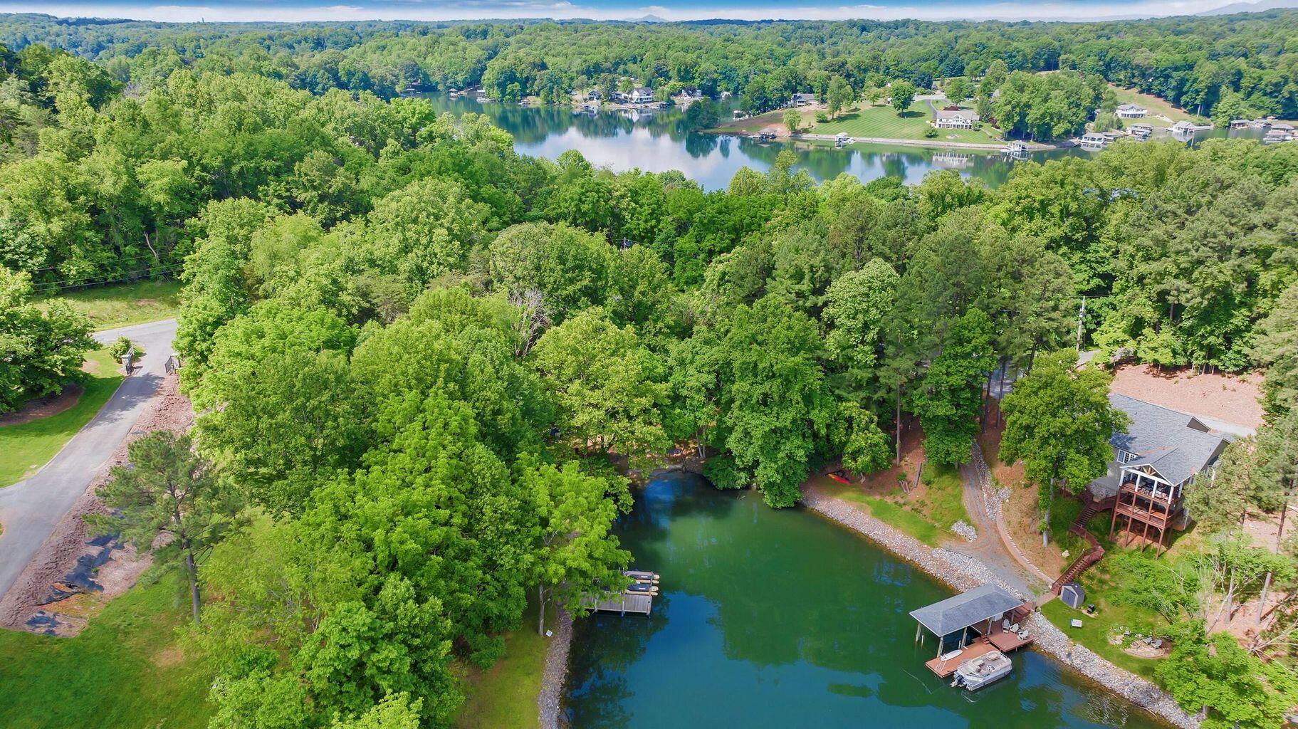 an aerial view of residential houses with outdoor space and swimming pool