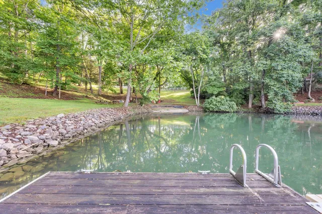 a view of a house with a yard and sitting area